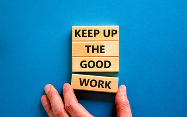 Wall Mural - Keep up the good work symbol. Concept words Keep up the good work on wooden blocks. Businessman hand. Beautiful blue table blue background. Keep up the good work business concept. Copy space.