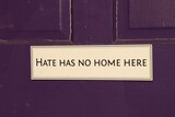 Fototapeta  - Anti-Hate Sign Hangs on Purple Door
