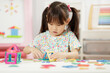 © M-image - Young Girl Playing Creative 3D Shape Toy For Homeschooling