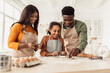© Prostock-studio - Black Family Making Cookies Using Baking Forms Cooking In Kitchen