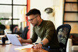 © JustLife - Young businessman using laptop in his office. Handsome man working on the project
