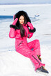 © Andrey_Arkusha - portrait of a young woman in a pink winter outfit with a fur hood
