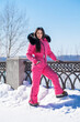 © Andrey_Arkusha - portrait of a young woman in a pink winter outfit with a fur hood