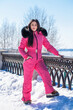 © Andrey_Arkusha - portrait of a young woman in a pink winter outfit with a fur hood
