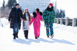 © Andrey_Arkusha - Young family of four walking outdoors in winter
