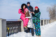 © Andrey_Arkusha - Young family of four walking outdoors in winter