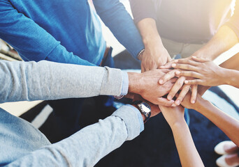 Wall Mural - Their secret is great teamwork. Cropped shot of a group of businesspeople standing in a huddle with their hands stacked.