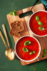 Wall Mural - tomato and bell pepper vegetarian soup on green background