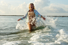 Happy Girl Running On Waves In Bali Island
