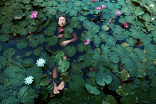 Beautiful Girl In The Lake With Lotuses