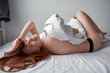 © Roman - happy sexy young redhead woman wake up lazy morning. Amazing female with sexy slim body enjoy morning, in cozy bedroom. natural beauty, lifestyle, people, positive emotions concept