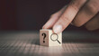 Hand flip magnifying glass and question mark sign icon in wooden cube. Problems and root cause analysis concept. copy space for background or text.