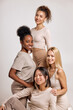 Portrait of cute happy female models posing, confident in themselves, isolated in studio. concept of different ethnicity of women being very close one to each other,expressing friendship