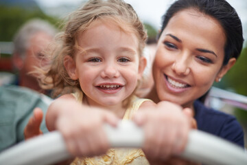 Sticker - We make everyday an adventure. Portrait of a little girl sitting on her mothers lap.