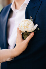 Wall Mural - Elegant boutonniere with white peony on the groom's jacket