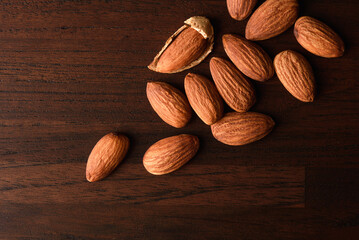 Wall Mural - almond nut on wood , cracked almond top view , healthy food nut 