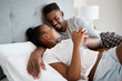 © Chanelle M/peopleimages.com - I love you with every fiber of my being. Shot of an affectionate young couple relaxing on their bed together at home.