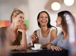 © T Hover/peopleimages.com - She knows how to get everyone smiling. Shot of three women enjoying a conversation in a restaurant.