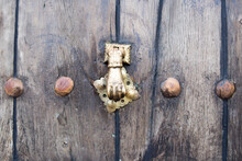 Knocker On Old Wooden Door With Golden Nails