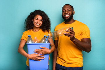 Wall Mural - Couple hold a plastic container with bottles as concept of ecology and recycling