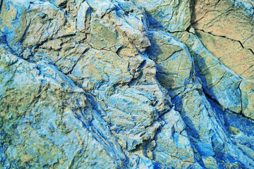 Wall Mural - abstract blue yellow brown background. colorful rock texture. cracked layered mountain surface. clos