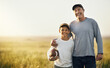 © Lyndon Stratford/peopleimages.com - We always bond over football. Shot of father and son playing football on an open field.