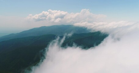 Wall Mural - aerial drone view over the mountain hills with a morning fog and clouds