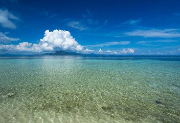 Wall Mural - Beautiful beach view with clear water and blue sky at Sibuan Island at Celebes sea in the vicinity of Sipidan Island and Tun Sakaran Marine Park. One of the dive site in Semporna, Sabah Borneo.