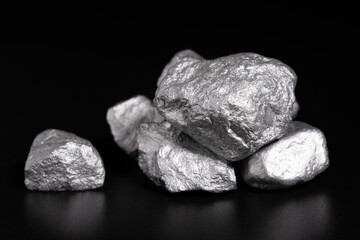 Canvas Print - lump of silver or platinum or rare earth minerals on black background