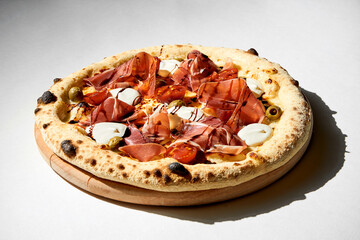 Wall Mural - Crispy pizza with jamon and cream cheese on a gray background.