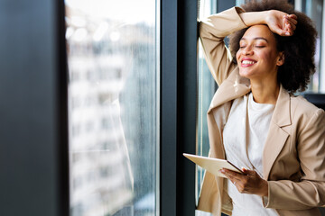 Sticker - Portrait of a smiling confident african american young businesswoman working with digital tablet