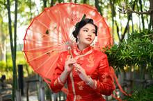 Asian Pretty Chinese Woman Dress Traditional Cheongsam Pose With Red Umbrella