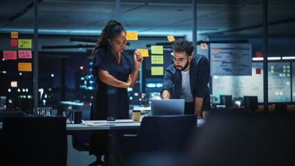 Wall Mural - Businesspeople in Modern Office: Business Meeting of Two Managers. Female CEO and Marketing Director Talk, Brainstorm Corporate Strategy, Implementing Marketing and Financial Plans. Evening Time.