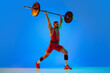 © master1305 - Studio shot of young man in red sportswear exercising with barbell isolated blue background in neon. Sport, weightlifting, power, achievements concept