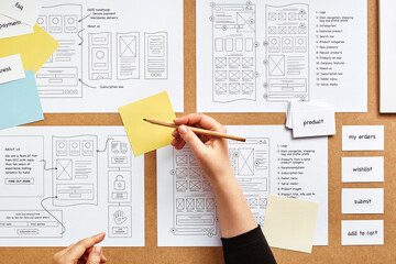 Wall Mural - web ux designer working on mobile responsive website project. flat lay image of numerous website wir