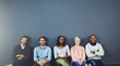 © Camerene Pendl/peopleimages.com - Everyday is friendship day with us. Studio shot of a diverse group of people sitting together on the floor against a gray background.