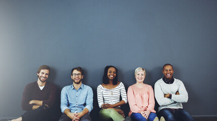 Aufkleber - Everyday is friendship day with us. Studio shot of a diverse group of people sitting together on the floor against a gray background.