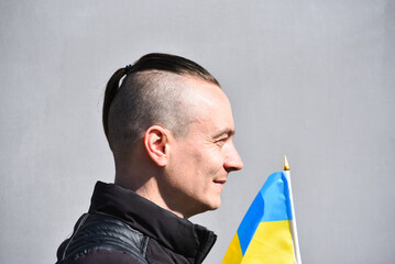 Portrait of men holding flag of Ukraine and watching distance,patriot kozak . Photo 