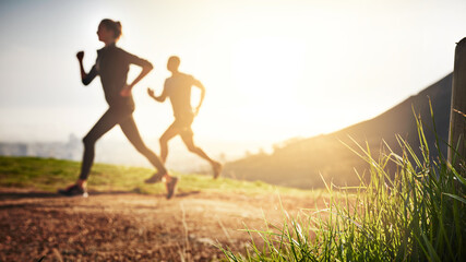 Poster - You have the ability to go to greater heights. Shot of a sporty couple out running on a mountain road.