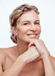 © Nicholas Felix/peopleimages.com - No one regrets a good skincare regime. Shot of a beautiful mature woman posing against a white background.