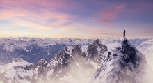 Adventurous Woman Hiker Standing On Top Of Icy Peak With Rocky Mountains In Background. Adventure Composite. 3d Rendering Rocks. Aerial Image Of Landscape From British Columbia, Canada. Sunset Sky