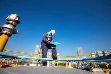 Male worker inspection recording visual roof storage tank oil