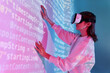 © ADDICTIVE STOCK - Woman in VR headset near wall with binary code