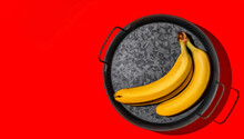 Ripe Bananas On A Metal Tray, Layout On Bright Red Background With Copy Space, Minimal Style Mockup. Yellow Tasty Fruits.