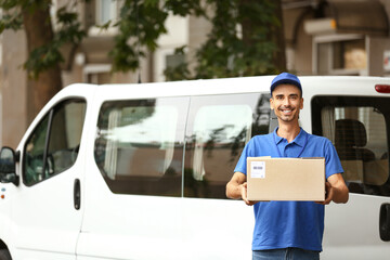 Poster - Male courier with parcel near automobile outdoors