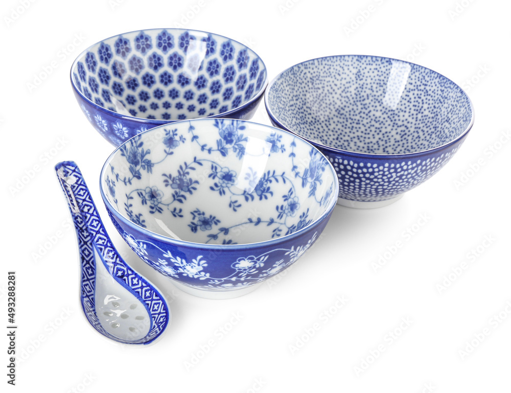 Chinese bowls with spoon on white background