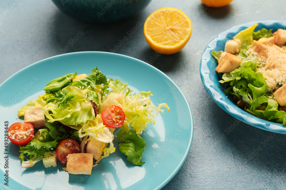 Plates with tasty vegan Caesar salad on color background, closeup