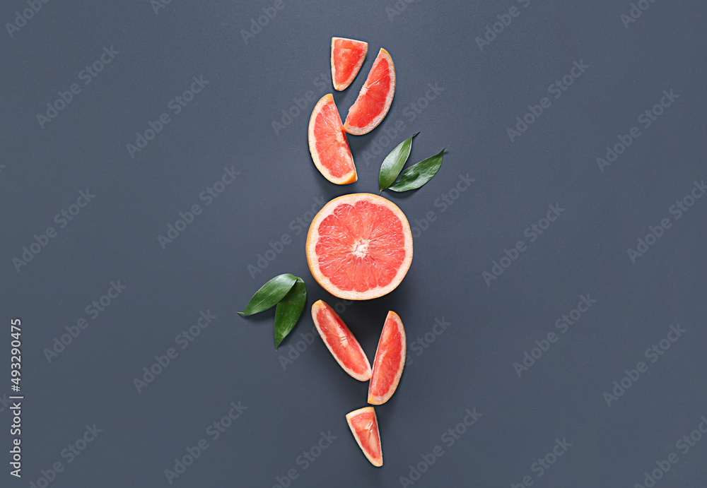 Fresh grapefruit pieces on dark background