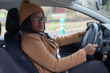 Portrait Of Black Woman Driving Car, Looking At Camera