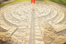 Woman Standing In The Center Of A Meditation Labyrinth